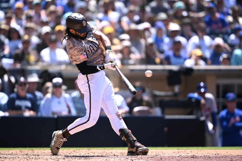 Jul 9, 2023; San Diego, California, USA; San Diego Padres right fielder Fernando Tatis Jr. (23) hits a single against the New York Mets during the fifth inning at Petco Park. Mandatory Credit: Orlando Ramirez-USA TODAY Sports