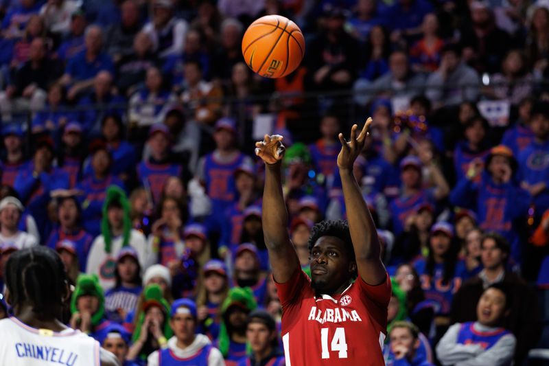 Feb 1, 2026; Gainesville, Florida, USA; Alabama Crimson Tide center Charles Bediako (14) shoots the ball over Florida Gators center Rueben Chinyelu (9) during the first half at Exactech Arena at the Stephen C. O'Connell Center. Mandatory Credit: Matt Pendleton-Imagn Images