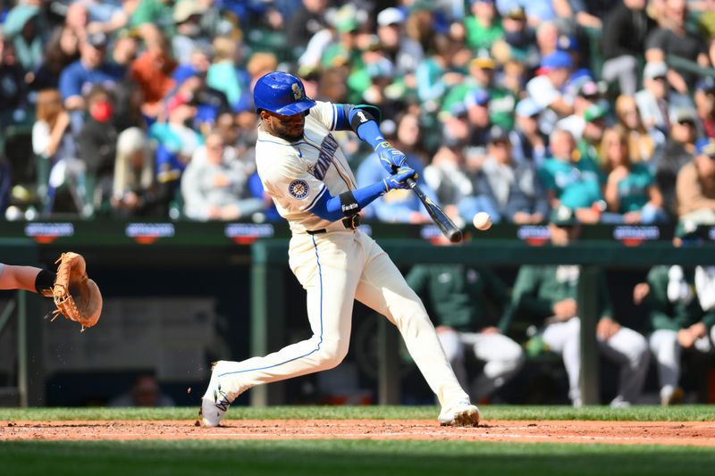 Sep 29, 2024; Seattle, Washington, USA; Seattle Mariners right fielder Victor Robles (10) hits an RBI double against the Oakland Athletics during the fifth inning at T-Mobile Park. Mandatory Credit: Steven Bisig-Imagn Images