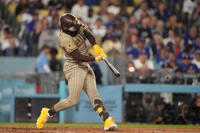 Sep 25, 2024; Los Angeles, California, USA;  San Diego Padres right fielder Fernando Tatis Jr. (23) hits a double in the third inning against the Los Angeles Dodgers at Dodger Stadium. Mandatory Credit: Kirby Lee-Imagn Images