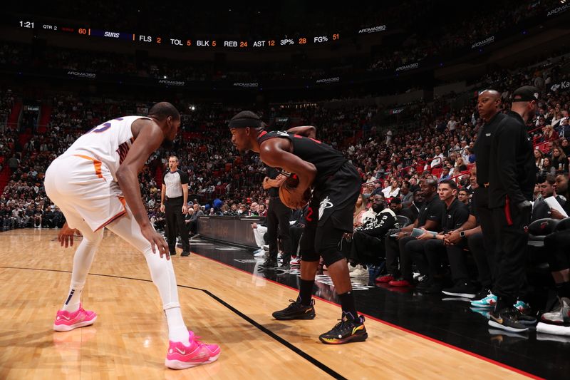 MIAMI, FL - JANUARY 29: Jimmy Butler #22 of the Miami Heat handles the ball while Kevin Durant #35 of the Phoenix Suns plays defense during the game on January 29, 2024 at Kaseya Center in Miami, Florida. NOTE TO USER: User expressly acknowledges and agrees that, by downloading and or using this Photograph, user is consenting to the terms and conditions of the Getty Images License Agreement. Mandatory Copyright Notice: Copyright 2024 NBAE (Photo by Issac Baldizon/NBAE via Getty Images)