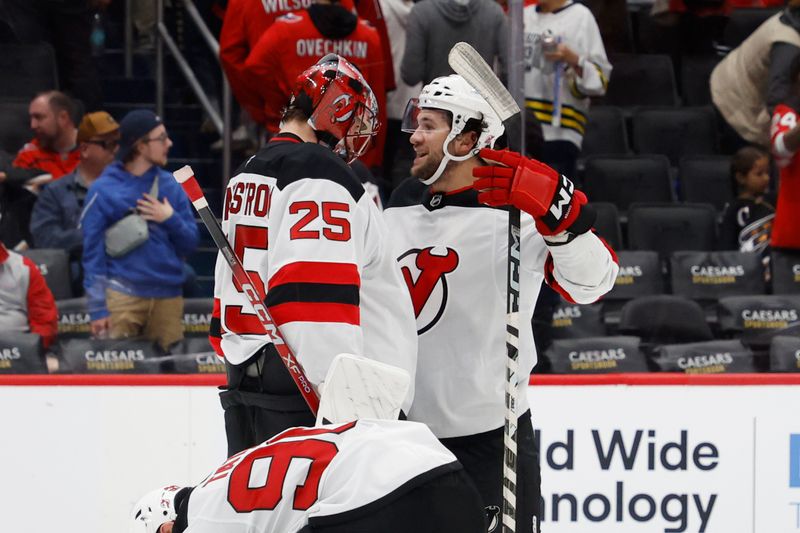 Oct 12, 2024; Washington, District of Columbia, USA; New Jersey Devils goaltender Jacob Markstrom (25) celebrates with Devils center Paul Cotter (47) after their game against the Washington Capitals at Capital One Arena. Mandatory Credit: Geoff Burke-Imagn Images