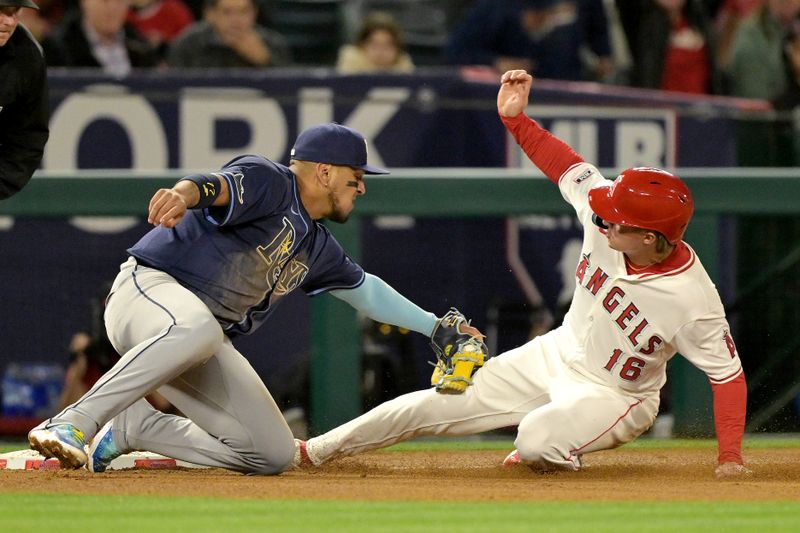 Apr 8, 2024; Anaheim, California, USA; Los Angeles Angels outfielder Mickey Moniak (16) is tagged out at third by Tampa Bay Rays third baseman Isaac Paredes (17) in the eighth inning at Angel Stadium. Mandatory Credit: Jayne Kamin-Oncea-USA TODAY Sports