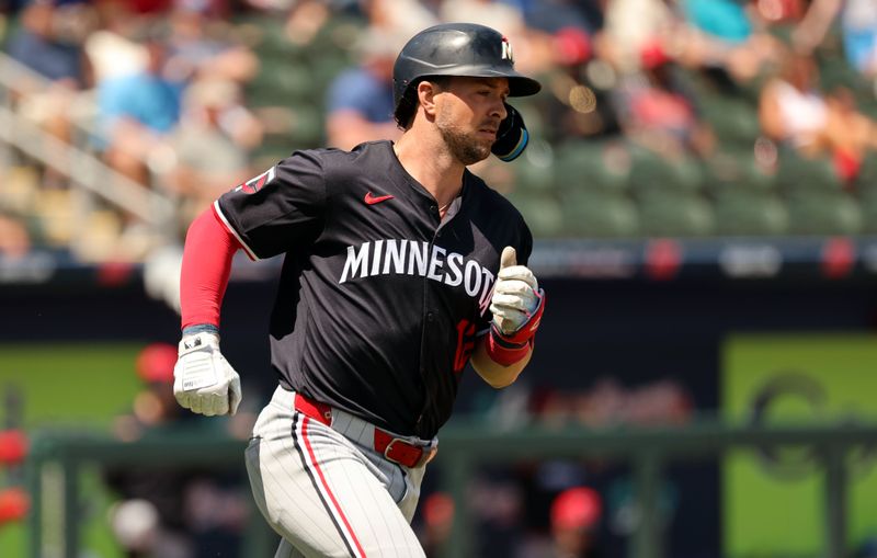 Mar 25, 2024; North Port, Florida, USA; Minnesota Twins second baseman Kyle Farmer (12) singles first inning against the Atlanta Braves  at CoolToday Park. Mandatory Credit: Kim Klement Neitzel-USA TODAY Sports