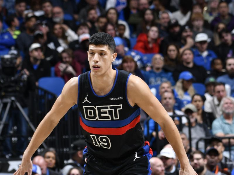 ORLANDO, FL - NOVEMBER 23: Simone Fontecchio #19 of the Detroit Pistons plays defense during the game against the Orlando Magic on November 23, 2024 at Kia Center in Orlando, Florida. NOTE TO USER: User expressly acknowledges and agrees that, by downloading and or using this photograph, User is consenting to the terms and conditions of the Getty Images License Agreement. Mandatory Copyright Notice: Copyright 2024 NBAE (Photo by Fernando Medina/NBAE via Getty Images)