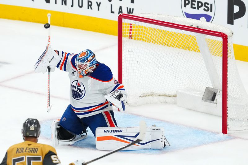 May 8, 2025; Las Vegas, Nevada, USA; Edmonton Oilers goaltender Calvin Pickard (30) deflects a Vegas Golden Knights shot with his stick during the third period of game two of the second round of the 2025 Stanley Cup Playoffs at T-Mobile Arena. Mandatory Credit: Stephen R. Sylvanie-Imagn Images