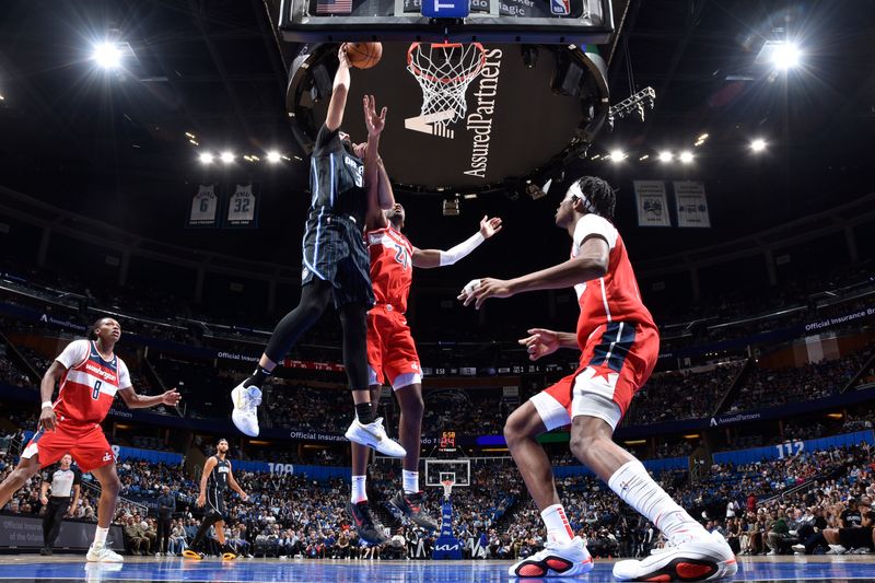 ORLANDO, FL - NOVMEBER 10: Goga Bitadze #35 of the Orlando Magic drives to the basket during the game against the Washington Wizards on November 10, 2024 at Kia Center in Orlando, Florida. NOTE TO USER: User expressly acknowledges and agrees that, by downloading and or using this photograph, User is consenting to the terms and conditions of the Getty Images License Agreement. Mandatory Copyright Notice: Copyright 2024 NBAE (Photo by Fernando Medina/NBAE via Getty Images)