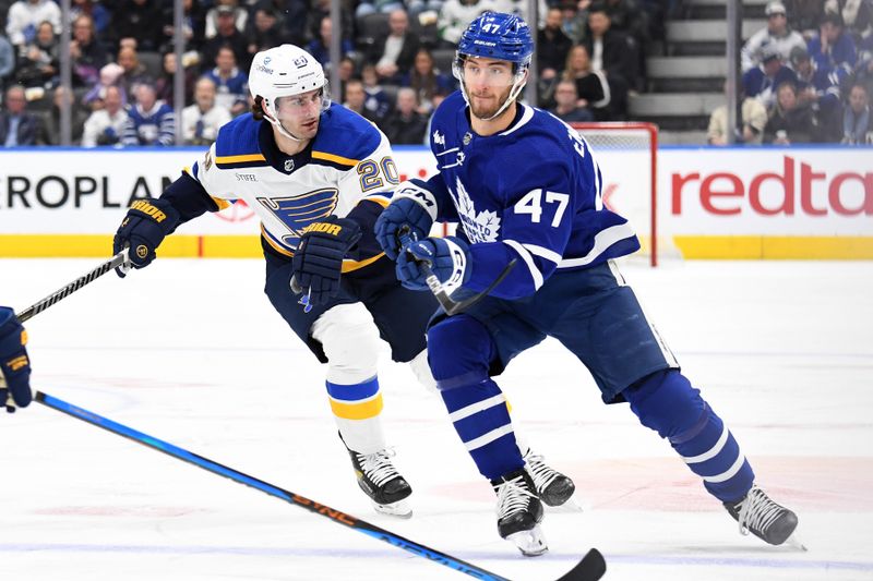 Jan 3, 2023; Toronto, Ontario, CAN; Toronto Maple Leafs forward Pierre Engvall (47) pursues the play ahead of St. Louis Blues forward Brandon Saad (20) in the first period at Scotiabank Arena. Mandatory Credit: Dan Hamilton-USA TODAY Sports