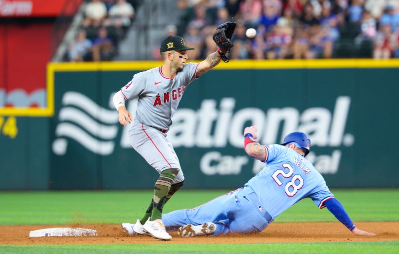 May 19, 2024; Arlington, Texas, USA; Texas Rangers catcher Jonah Heim (28) slides safely into second base ahead of the tag by Los Angeles Angels shortstop Zach Neto (9) during the seventh inning at Globe Life Field. Mandatory Credit: Kevin Jairaj-USA TODAY Sports