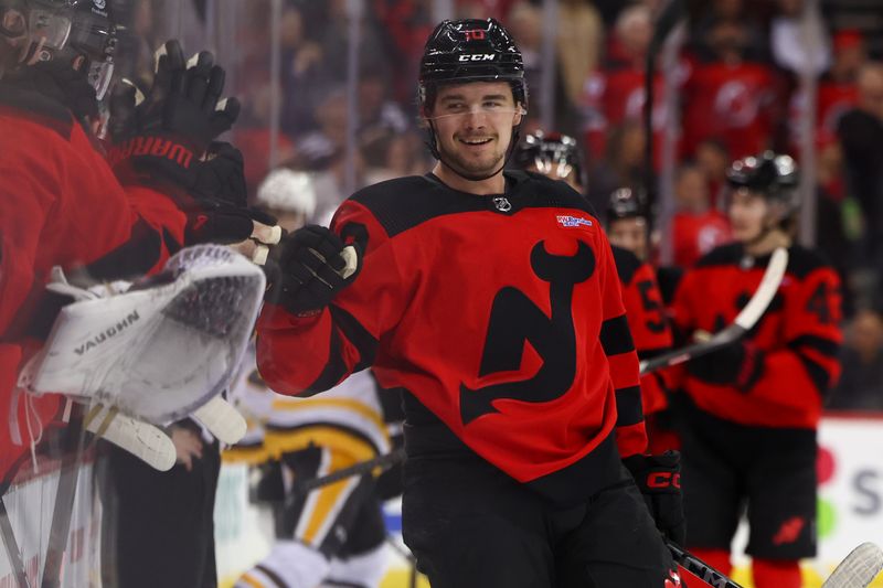 Mar 19, 2024; Newark, New Jersey, USA; New Jersey Devils right wing Alexander Holtz (10) celebrates his goal against the Pittsburgh Penguins during the third period at Prudential Center. Mandatory Credit: Ed Mulholland-USA TODAY Sports