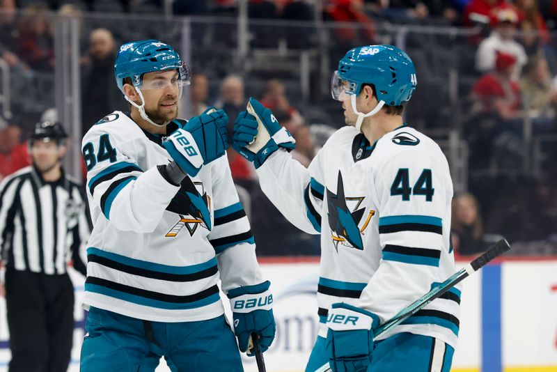 Jan 14, 2025; Detroit, Michigan, USA;  San Jose Sharks defenseman Jan Rutta (84) celebrates with defenseman Marc-Edouard Vlasic (44) after scoring in the first period against the Detroit Red Wings at Little Caesars Arena. Mandatory Credit: Rick Osentoski-Imagn Images