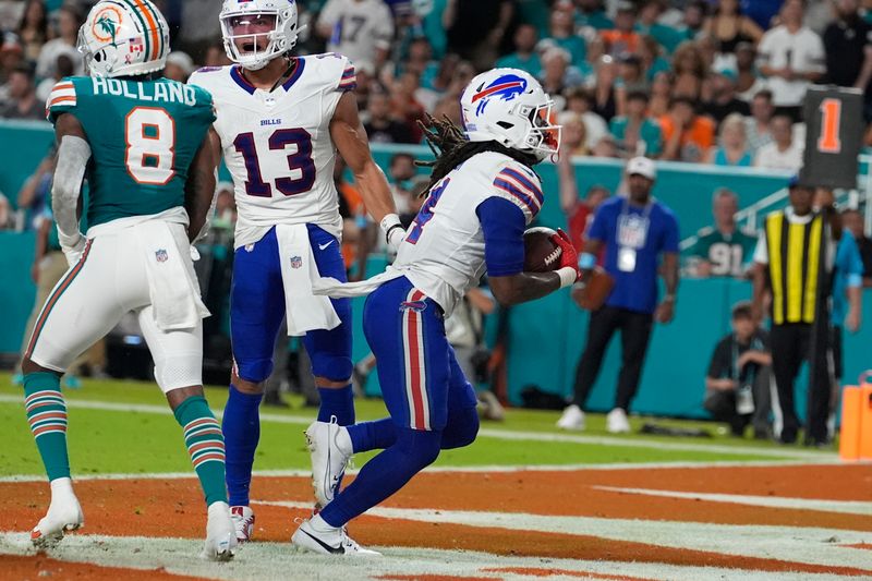 Buffalo Bills running back James Cook (4) runs into the endzone for a touchdown during the first half of an NFL football game against the Miami Dolphins, Thursday, Sept. 12, 2024, in Miami Gardens, Fla. (AP Photo/Lynne Sladky)