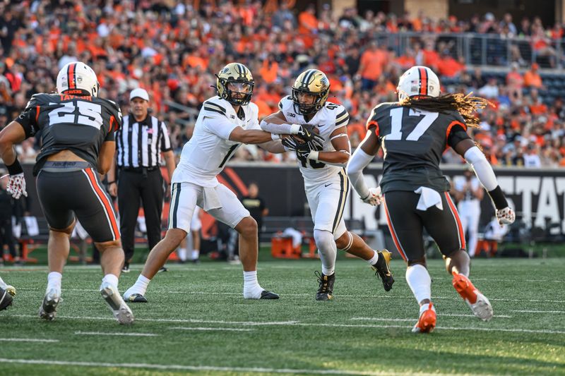 Sep 21, 2024; Corvallis, Oregon, USA; Purdue Boilermakers quarterback Hudson Card (1) hands the ball to running back Devin Mockobee (45) during the first half against the Oregon State Beavers at Reser Stadium. Mandatory Credit: Craig Strobeck-Imagn Images