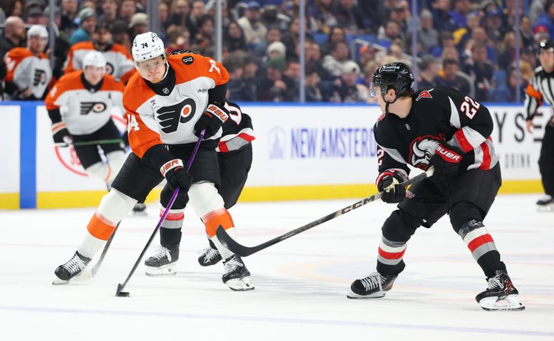 Dec 18, 2025; Buffalo, New York, USA;  Philadelphia Flyers right wing Owen Tippett (74) controls the puck as Buffalo Sabres right wing Jack Quinn (22) defends during the first period at KeyBank Center. Mandatory Credit: Timothy T. Ludwig-Imagn Images