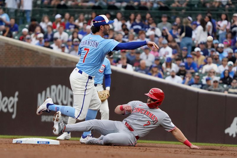 May 30, 2025; Chicago, Illinois, USA; Chicago Cubs shortstop Dansby Swanson (7) forces out Cincinnati Reds first base Spencer Steer (7) at second base during the first inning at Wrigley Field. Mandatory Credit: David Banks-Imagn Images