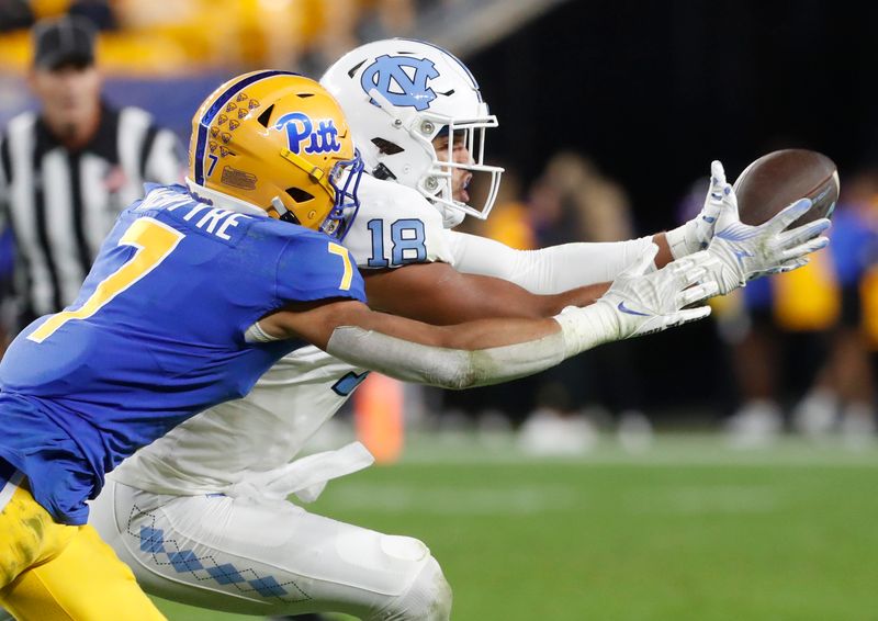 Sep 23, 2023; Pittsburgh, Pennsylvania, USA; North Carolina Tar Heels tight end Bryson Nesbit (18) makes a catch against Pittsburgh Panthers defensive back Javon McIntyre (7) during the third quarter at Acrisure Stadium. Mandatory Credit: Charles LeClaire-USA TODAY Sports