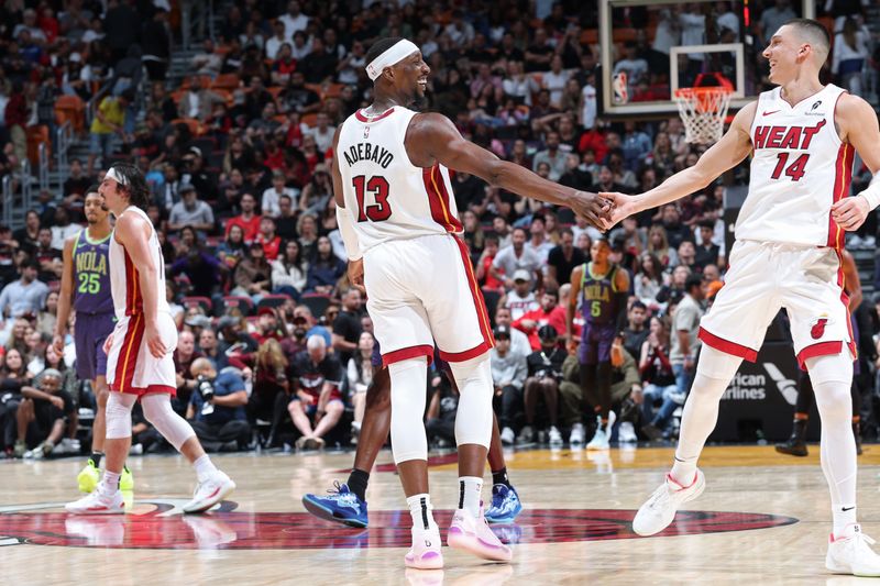 MIAMI, FL - JANUARY 1: Bam Adebayo #13 and Tyler Herro #14 of the Miami Heat high five during the game against the New Orleans Pelicans on January 1, 2025 at Kaseya Center in Miami, Florida. NOTE TO USER: User expressly acknowledges and agrees that, by downloading and or using this Photograph, user is consenting to the terms and conditions of the Getty Images License Agreement. Mandatory Copyright Notice: Copyright 2024 NBAE (Photo by Jeff Haynes/NBAE via Getty Images)
