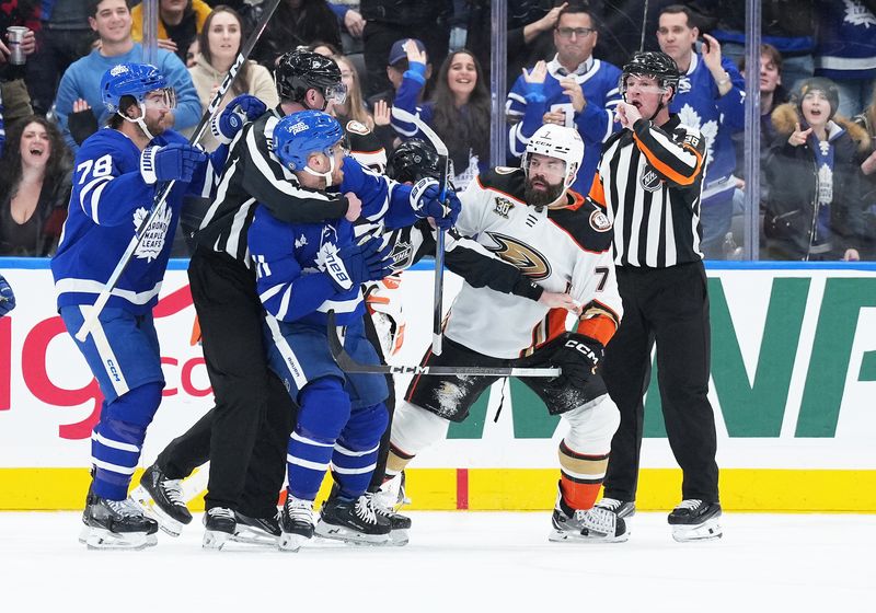 Feb 17, 2024; Toronto, Ontario, CAN; Toronto Maple Leafs center Max Domi (11) fights Anaheim Ducks defenseman Radko Gudas (7) during the second period at Scotiabank Arena. Mandatory Credit: Nick Turchiaro-USA TODAY Sports