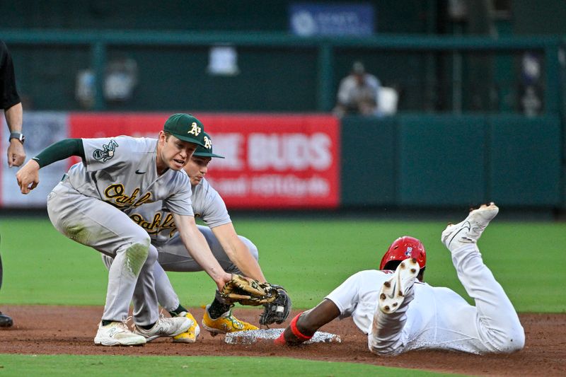 Aug 14, 2023; St. Louis, Missouri, USA;  Oakland Athletics second baseman Zack Gelof (20) and shortstop Nick Allen (2) cover second base as St. Louis Cardinals right fielder Jordan Walker (18) steals during the second inning at Busch Stadium. Mandatory Credit: Jeff Curry-USA TODAY Sports