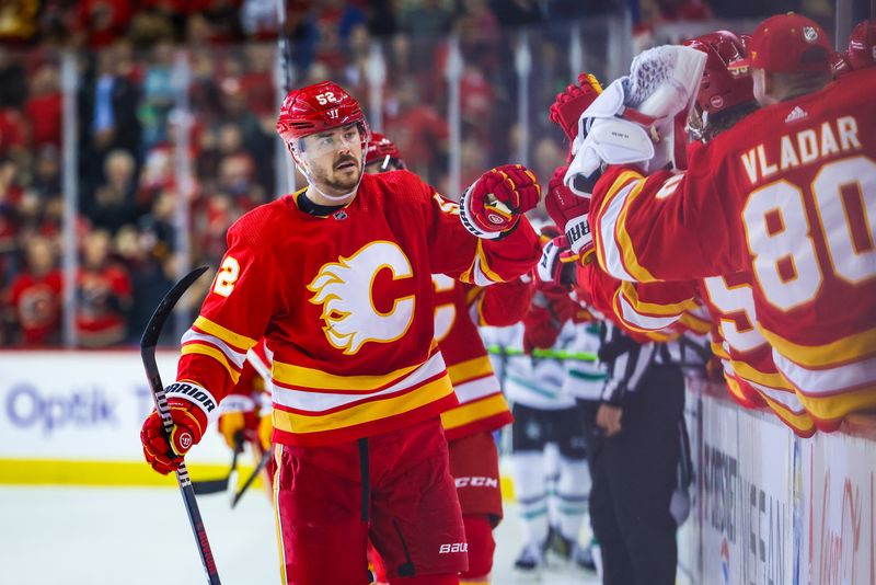 Nov 30, 2023; Calgary, Alberta, CAN; Calgary Flames defenseman MacKenzie Weegar (52) celebrates his goal with teammates against the Dallas Stars during the third period at Scotiabank Saddledome. Mandatory Credit: Sergei Belski-USA TODAY Sports