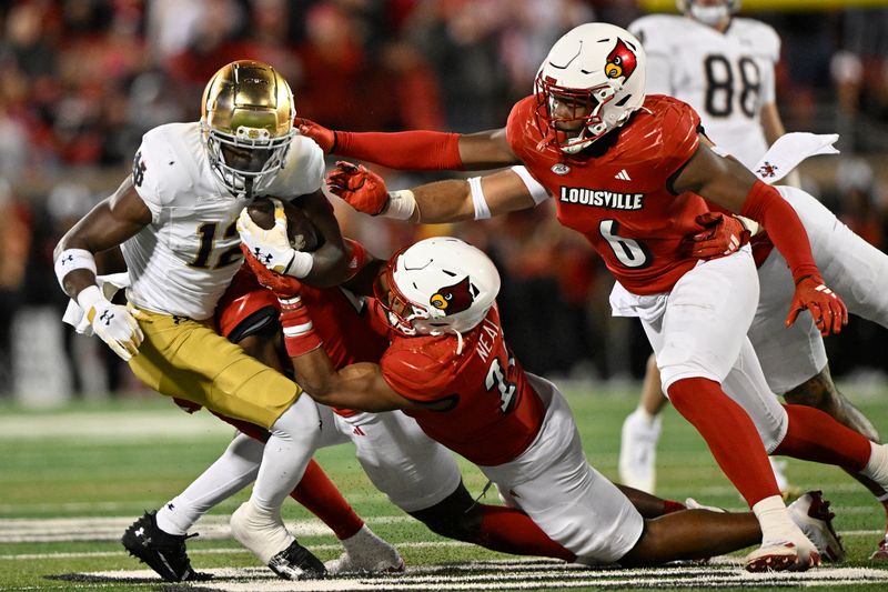 Oct 7, 2023; Louisville, Kentucky, USA; Louisville Cardinals defensive back Devin Neal (27) and Louisville Cardinals linebacker Stanquan Clark (6) tackle Notre Dame Fighting Irish running back Jeremiyah Love (12) during the second half at L&N Federal Credit Union Stadium. Louisville defeated Notre Dame 33-20. Mandatory Credit: Jamie Rhodes-USA TODAY Sports