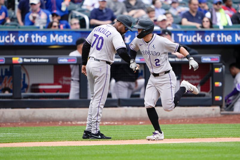 Jun 1, 2025; New York City, New York, USA; Colorado Rockies third base coach Andy Gonzalez (70) congratulates Colorado Rockies right fielder Tyler Freeman (2) for hitting a home run against the New York Mets during the fifth inning at Citi Field. Mandatory Credit: Gregory Fisher-Imagn Images
