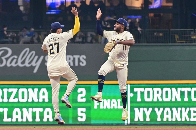 Apr 7, 2024; Milwaukee, Wisconsin, USA; Milwaukee Brewers shortstop Willy Adames (27) celebrates with right fielder Jackson Chourio (11) after defeating the Seattle Mariners at American Family Field. Mandatory Credit: Benny Sieu-USA TODAY Sports