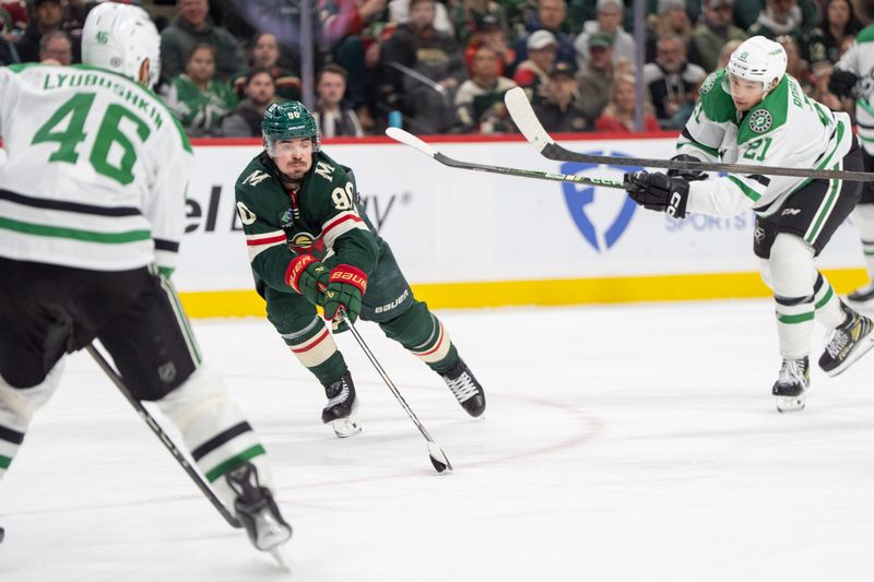 Apr 6, 2025; Saint Paul, Minnesota, USA; Minnesota Wild left wing Marcus Johansson (90) secures a loose puck between the defense of Dallas Stars left wing Jason Robertson (21) and defenseman Ilya Lyubushkin (46) in the second period at Xcel Energy Center. Mandatory Credit: Matt Blewett-Imagn Images