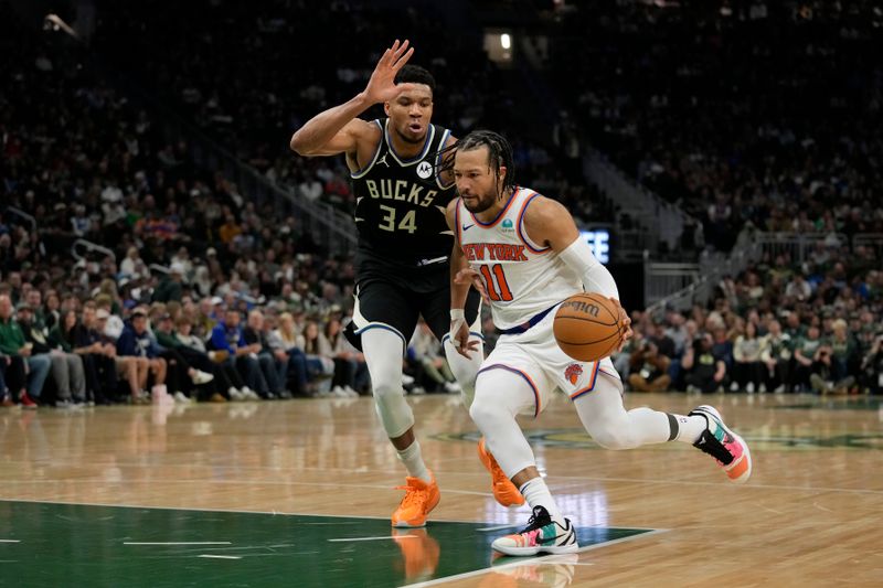 MILWAUKEE, WISCONSIN - APRIL 07: Jalen Brunson #11 of the New York Knicks dribbles the ball against Giannis Antetokounmpo #34 of the Milwaukee Bucks during the second half at Fiserv Forum on April 07, 2024 in Milwaukee, Wisconsin. NOTE TO USER: User expressly acknowledges and agrees that, by downloading and or using this photograph, User is consenting to the terms and conditions of the Getty Images License Agreement. (Photo by Patrick McDermott/Getty Images)