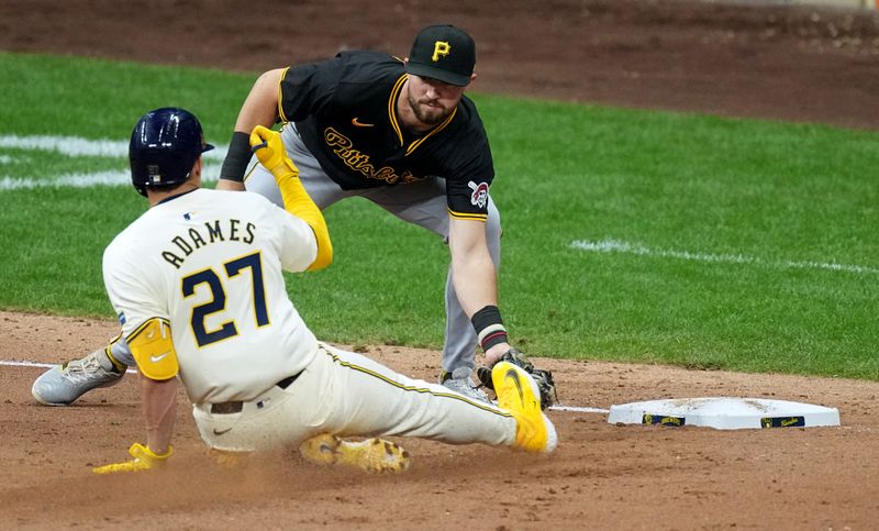 May 13, 2024; Milwaukee, Wisconsin, USA;  Milwaukee Brewers shortstop Willy Adames (27) is tagged out by Pittsburgh Pirates second base Jared Triolo (19) after hitting a two-run double to deep right during the seventh inning at American Family Field. Mandatory Credit: Mark Hoffman-USA TODAY Sports