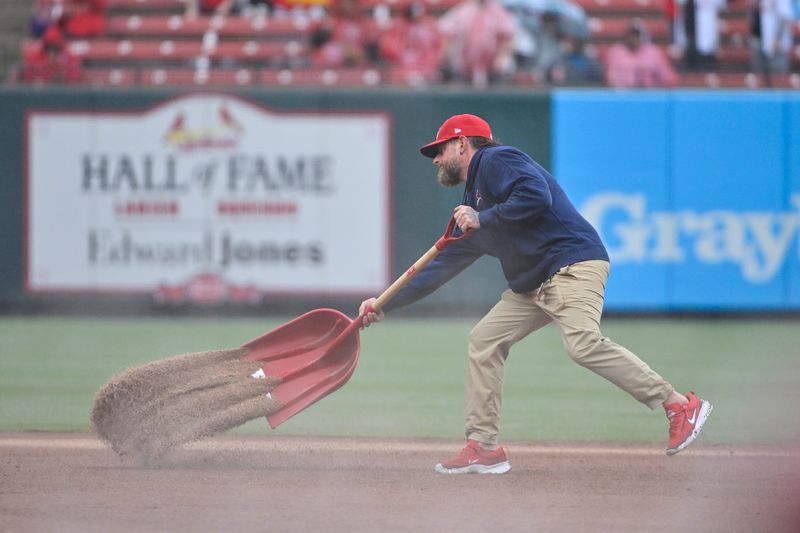 Apr 10, 2024; St. Louis, Missouri, USA;  St. Louis Cardinals grounds crew put quick dry on the field during the sixth inning of a game against the Philadelphia Phillies at Busch Stadium. Mandatory Credit: Jeff Curry-USA TODAY Sports