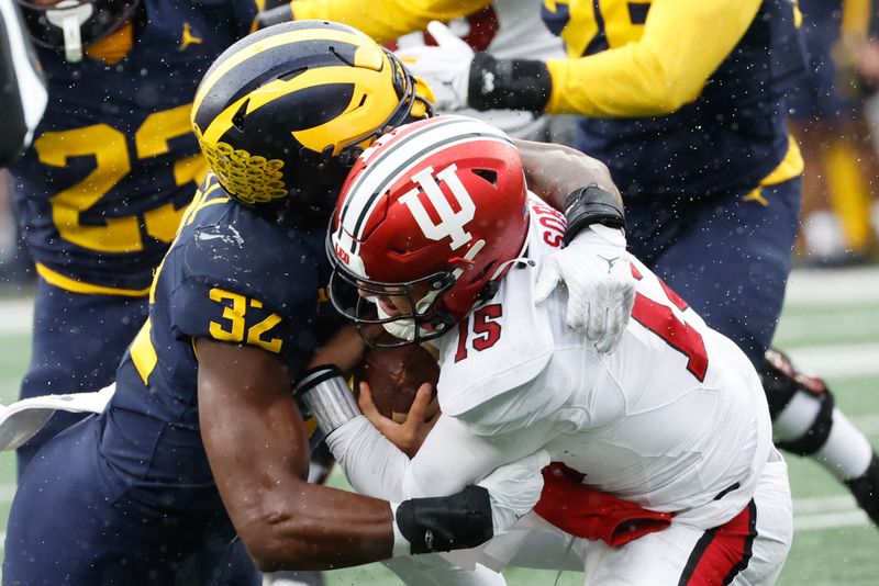 Oct 14, 2023; Ann Arbor, Michigan, USA; Michigan Wolverines defensive end Jaylen Harrell (32) sacks Indiana Hoosiers quarterback Brendan Sorsby (15) in the second half at Michigan Stadium. Mandatory Credit: Rick Osentoski-USA TODAY Sports