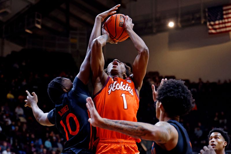 Jan 4, 2025; Blacksburg, Virginia, USA; Miami Hurricanes guard Paul Djobet (10) blocks a shot by Virginia Tech Hokies forward Tobi Lawal (1) during the first half at Cassell Coliseum. Mandatory Credit: Peter Casey-Imagn Images