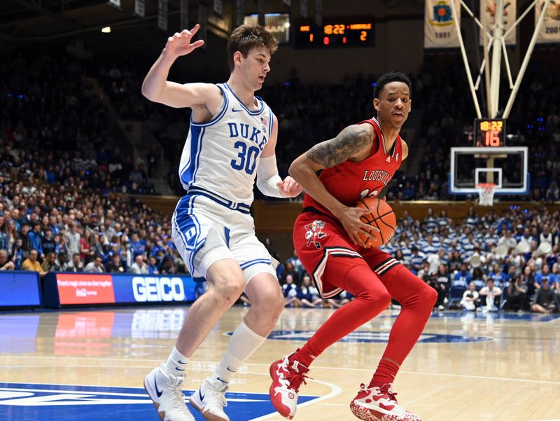 Feb 20, 2023; Durham, North Carolina, USA; Louisville Cardinals forward JJ Traynor (12) controls the ball in front of Duke Blue Devils center Kyle Filipowski(30) during the first half at Cameron Indoor Stadium. Mandatory Credit: Rob Kinnan-USA TODAY Sports