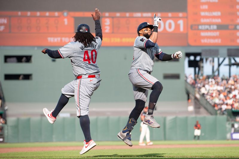 Jul 13, 2024; San Francisco, California, USA; Minnesota Twins first base Carlos Santana (30) celebrates with third base coach/outfield coach Tommy Watkins (40) after hitting a home run against the San Francisco Giants during the sixth inning at Oracle Park. Mandatory Credit: Ed Szczepanski-USA TODAY Sports