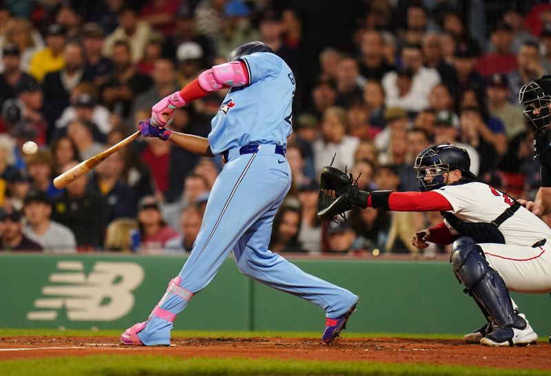 Aug 29, 2024; Boston, Massachusetts, USA; Toronto Blue Jays designated hitter Vladimir Guerrero Jr. (27) hits a double to drive in a run against the Boston Red Sox  in the third inning at Fenway Park. Mandatory Credit: David Butler II-USA TODAY Sports