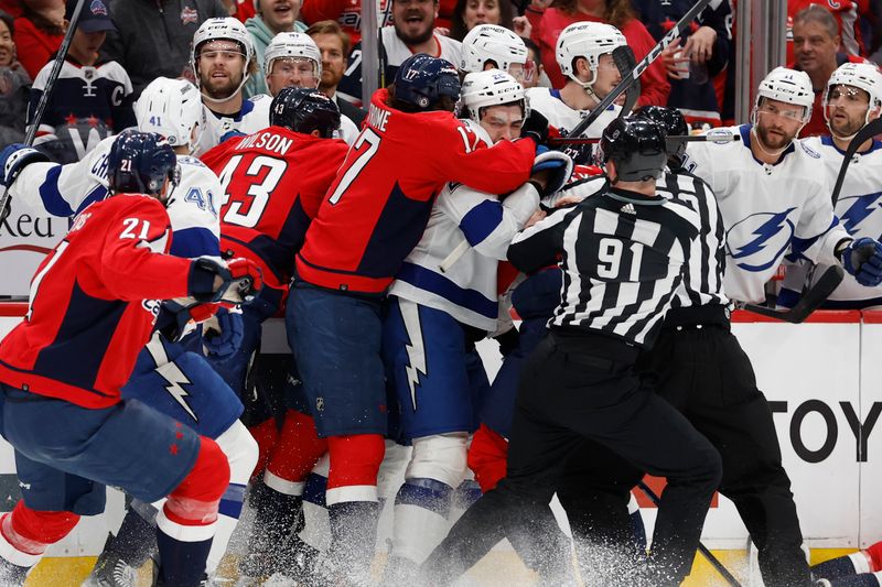 Apr 13, 2024; Washington, District of Columbia, USA; Washington Capitals players charge Tampa Bay Lightning center Michael Eyssimont (23) after a hit that injured Capitals defenseman Nick Jensen (not pictured) in the first period at Capital One Arena. Mandatory Credit: Geoff Burke-USA TODAY Sports