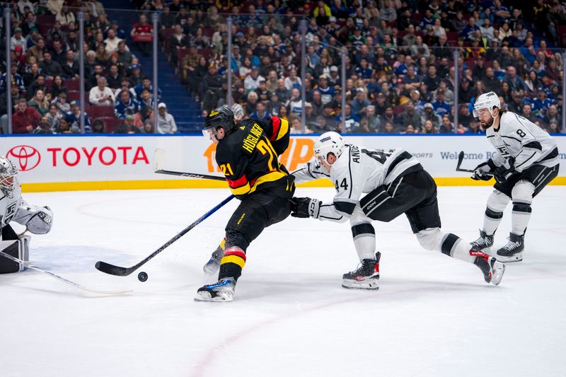 Mar 25, 2024; Vancouver, British Columbia, CAN; Los Angeles Kings defenseman Drew Doughty (8) watches as defenseman Mikey Anderson (44) stick checks Vancouver Canucks forward Nils Hoglander (21) in the first period at Rogers Arena. Mandatory Credit: Bob Frid-USA TODAY Sports