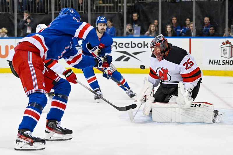 Dec 2, 2024; New York, New York, USA;  New Jersey Devils goaltender Jacob Markstrom (25) makes a save on New York Rangers defenseman K'Andre Miller (79) during the second period at Madison Square Garden. Mandatory Credit: Dennis Schneidler-Imagn Images