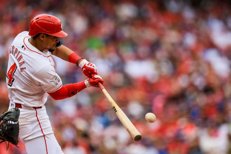 May 26, 2024; Cincinnati, Ohio, USA; Cincinnati Reds third baseman Santiago Espinal (4) hits a single against the Los Angeles Dodgers in the eighth inning at Great American Ball Park. Mandatory Credit: Katie Stratman-USA TODAY Sports