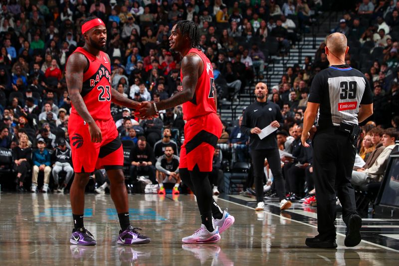 BROOKLYN, NY - OCTOBER 18: Jamal Shead #23 and Davion Mitchell #45 of the Toronto Raptors high five during the game on October 18, 2024 at Barclays Center in Brooklyn, New York. NOTE TO USER: User expressly acknowledges and agrees that, by downloading and or using this Photograph, user is consenting to the terms and conditions of the Getty Images License Agreement. Mandatory Copyright Notice: Copyright 2024 NBAE (Photo by David L. Nemec/NBAE via Getty Images)