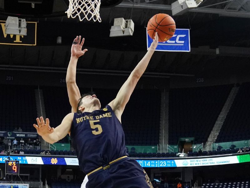 Mar 7, 2023; Greensboro, NC, USA; Notre Dame Fighting Irish guard Cormac Ryan (5) drives to the basket against the Virginia Tech Hokies during the second half of the first round of the ACC tournament at Greensboro Coliseum. Mandatory Credit: John David Mercer-USA TODAY Sports