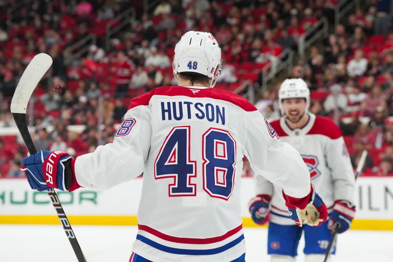 Jan 1, 2026; Raleigh, North Carolina, USA;  Montréal Canadiens defenseman Lane Hutson (48) celebrates his empty net goal with defenseman Alexandre Carrier (45) against the Carolina Hurricanes during the third period at Lenovo Center. Mandatory Credit: James Guillory-Imagn Images