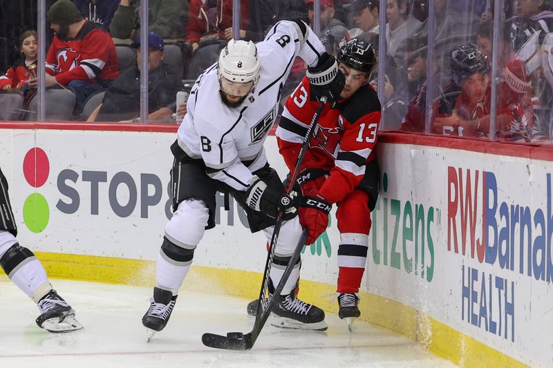 Feb 23, 2023; Newark, New Jersey, USA; Los Angeles Kings defenseman Drew Doughty (8) and New Jersey Devils center Nico Hischier (13) battle for the puck during the second period at Prudential Center. Mandatory Credit: Ed Mulholland-USA TODAY Sports