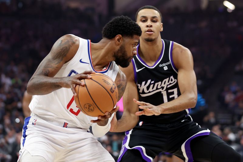 SACRAMENTO, CALIFORNIA - APRIL 02: Keegan Murray #13 of the Sacramento Kings guards Paul George #13 of the LA Clippersin the first half at Golden 1 Center on April 02, 2024 in Sacramento, California. NOTE TO USER: User expressly acknowledges and agrees that, by downloading and or using this photograph, User is consenting to the terms and conditions of the Getty Images License Agreement.  (Photo by Ezra Shaw/Getty Images)