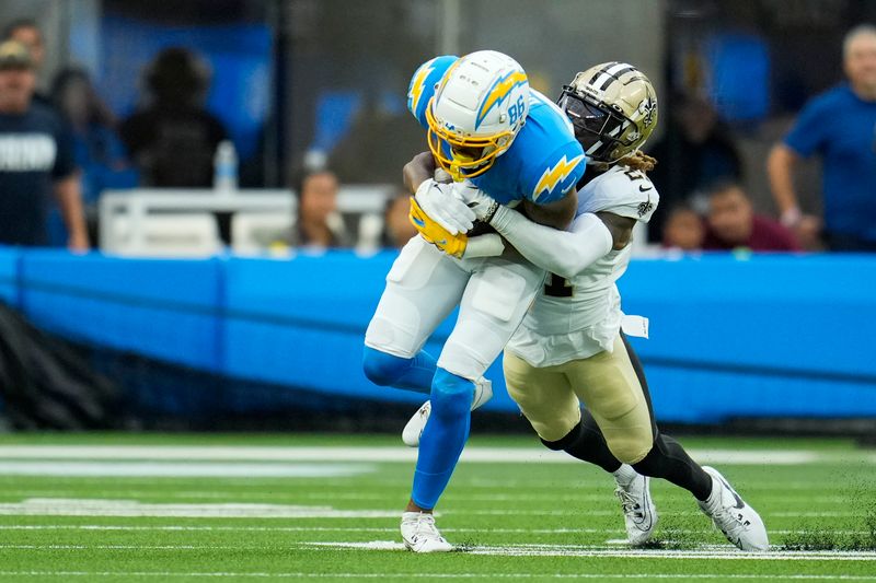 Los Angeles Chargers wide receiver Keelan Doss (86) is tackled by New Orleans Saints cornerback Bradley Roby in the first half of an NFL football game in Inglewood, Calif., Sunday, Aug. 20, 2023. (AP Photo/Marcio Jose Sanchez)