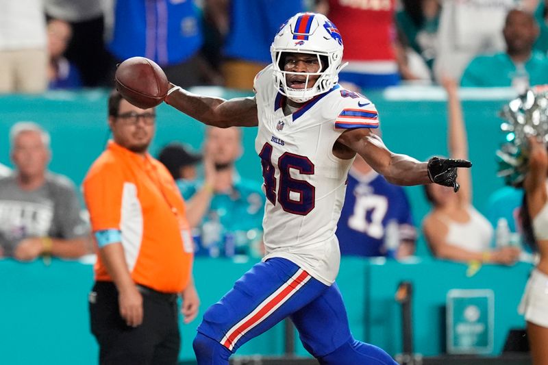 Buffalo Bills cornerback Ja'Marcus Ingram (46) runs for a touchdown after intercepting a pass during the second half of an NFL football game against the Miami Dolphins, Thursday, Sept. 12, 2024, in Miami Gardens, Fla. (AP Photo/Rebecca Blackwell)