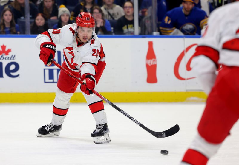 Jan 15, 2025; Buffalo, New York, USA;  Carolina Hurricanes center Sebastian Aho (20) makes a pass during the first period against the Buffalo Sabres at KeyBank Center. Mandatory Credit: Timothy T. Ludwig-Imagn Images