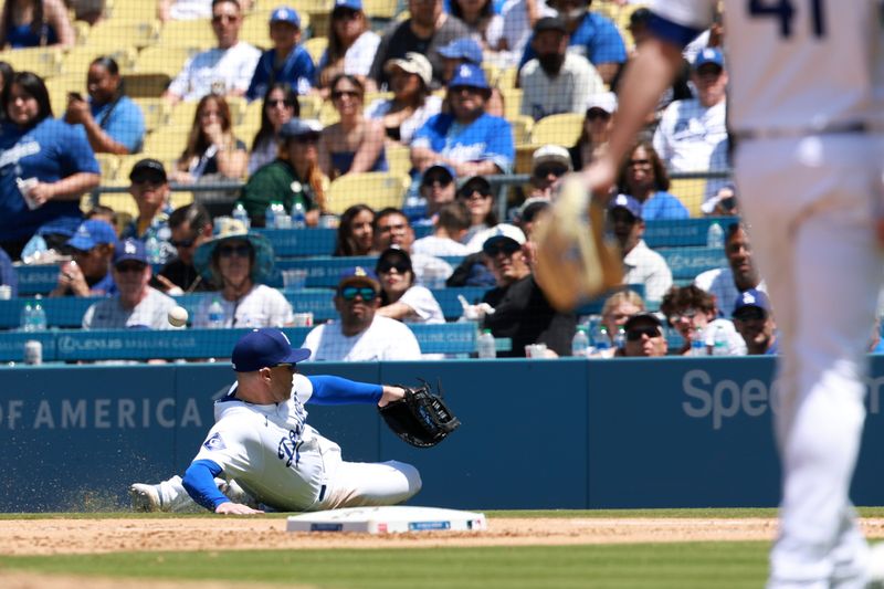 May 8, 2024; Los Angeles, California, USA;  Los Angeles Dodgers first base Freddie Freeman (5) dives for a fly ball in a foul territory during the ninth inning against the Miami Marlins at Dodger Stadium. Mandatory Credit: Kiyoshi Mio-USA TODAY Sports