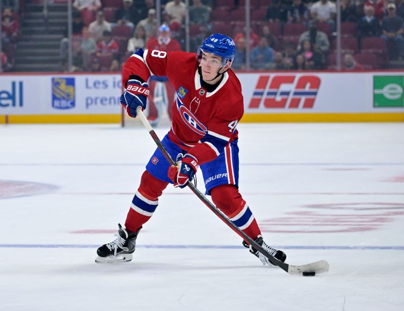 Sep 23, 2025; Montreal, Quebec, CAN; Montreal Canadiens defenseman Lane Hutson (48) plays the puck during the first period against the Philadelphia Flyers at the Bell Centre. Mandatory Credit: Eric Bolte-Imagn Images